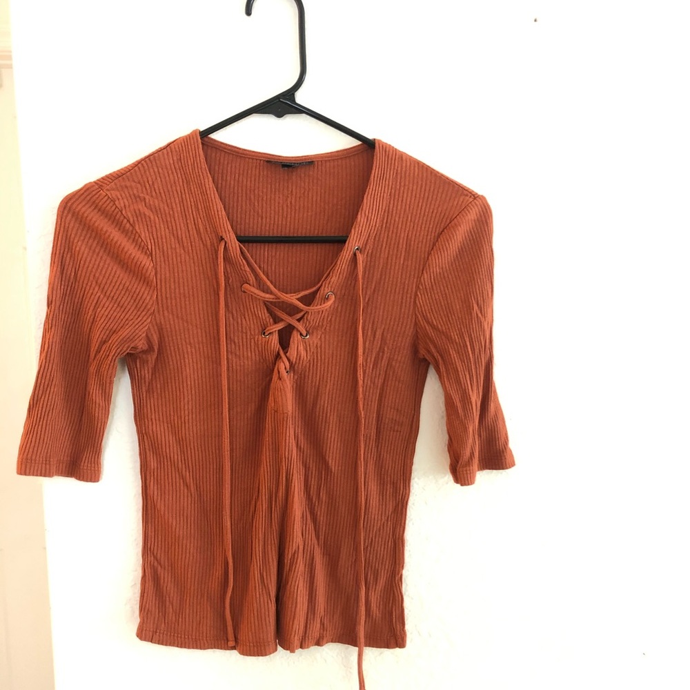 Burnt orange shirt.